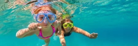 kids swimming underwater with scuba masks