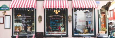 storefront of shops with a striped awning