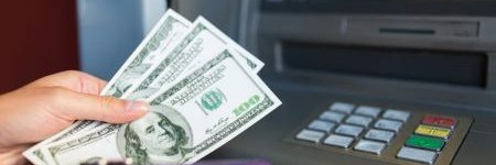 customer accessing money from a bank ATM