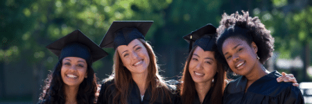 group of smiling women college graduates