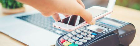 person using a phone to make a digital payment in a store