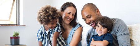 family laughing with money saved in a personal savings account