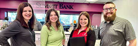 1st summit bank bank employees in a line smiling waiting to meet you