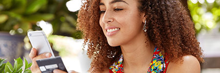 woman shopping on phone with personal credit card