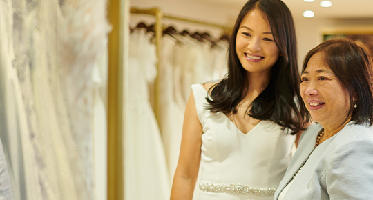 mom and daughter shopping for wedding dresses