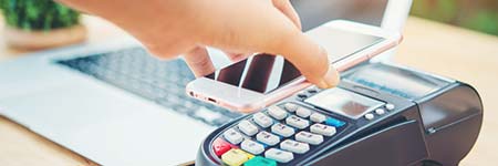 person using a phone to make a digital payment in a store