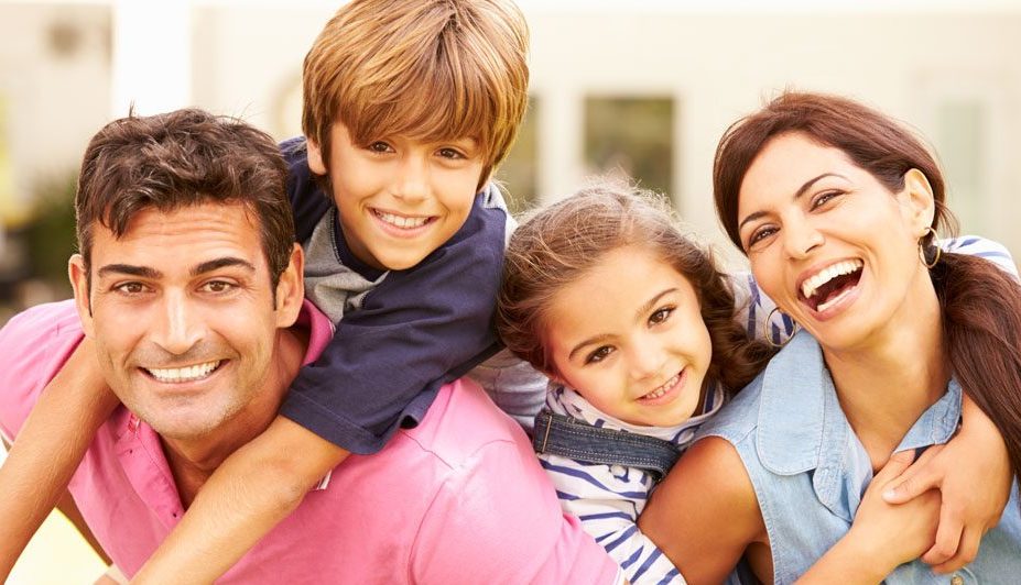 family laughing and smiling with their new health plan