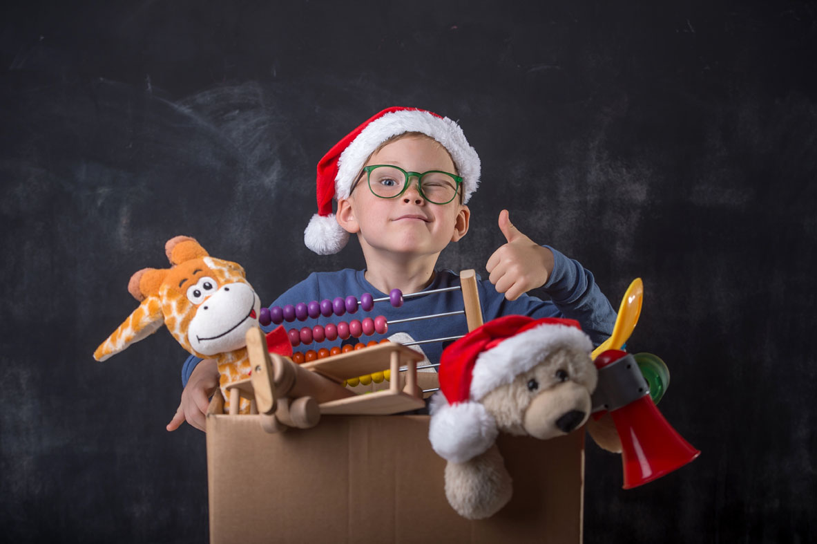family and charitable giving with a boy donating his toys