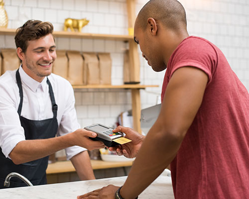 guy purchasing at a local merchant discount stores with his 1st summit card