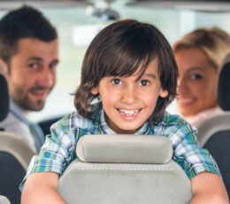 a group of children sitting in the back of a car.