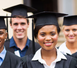 a group of people in graduation gowns posing for a picture.