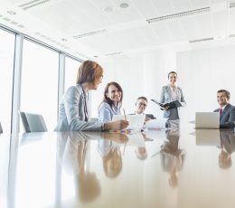 a group of people sitting around a conference table.