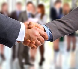 a close up of two people shaking hands.