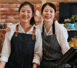 mom and daughter behind the counter of their business