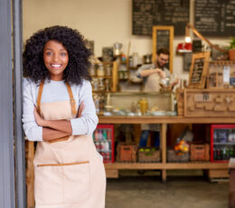 lady in an apron at work smiling