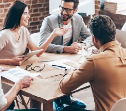 colleagues sitting at a table in a meeting