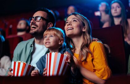 family in the movie theater eating popcorn
